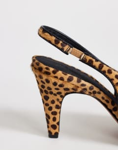 Model wearing Arabella cone heel sling back court shoe in deer print