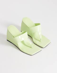 Model wearing Archer toe thong wedge heel in lime