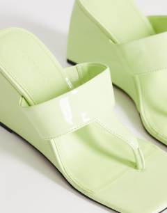 Model wearing Archer toe thong wedge heel in lime
