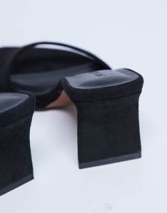 Model wearing Ari mule heeled sandal in black