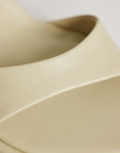 Model wearing Ari mule heeled sandal in off white