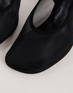 Model wearing Arrow sling back mesh heeled shoe in black