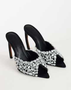 Model wearing Artemis banana heel mule with hand sewn gems in black