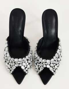 Model wearing Artemis banana heel mule with hand sewn gems in black
