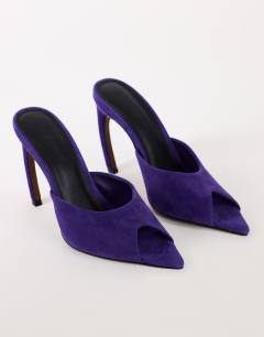 Model wearing Artemis real suede banana heel mule in purple