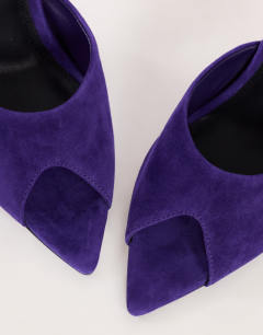 Model wearing Artemis real suede banana heel mule in purple