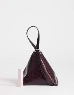 Model wearing Arthur multi wear bag in burgundy