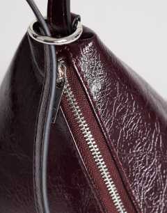 Model wearing Arthur multi wear bag in burgundy