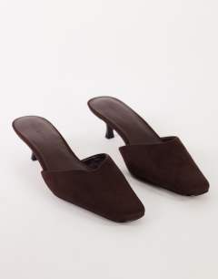 Model wearing Arthur rounded toe mid heel mule in chocolate faux suede