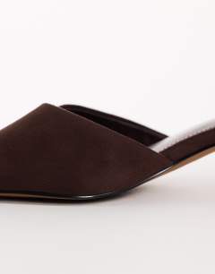 Model wearing Arthur rounded toe mid heel mule in chocolate faux suede