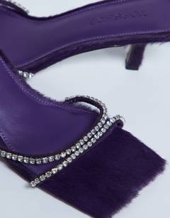 Model wearing Astrid diamante heeled mule in purple real leather pony