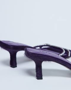 Model wearing Astrid diamante heeled mule in purple real leather pony