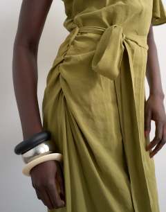 Model wearing Asym sleeve tie waist cupro maxi occasion dress in khaki