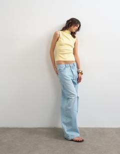 Model wearing Asymmetric button detail sleeveless in buttermilk