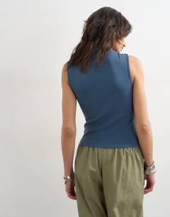 Model wearing Asymmetric button detail sleeveless in deep blue
