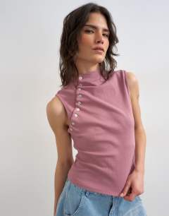 Model wearing Asymmetric button detail sleeveless in mauve