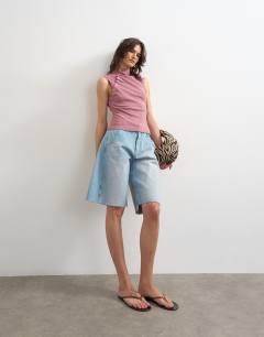 Model wearing Asymmetric button detail sleeveless in mauve