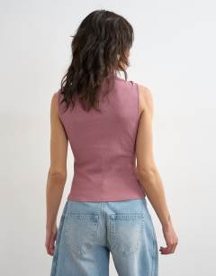 Model wearing Asymmetric button detail sleeveless in mauve