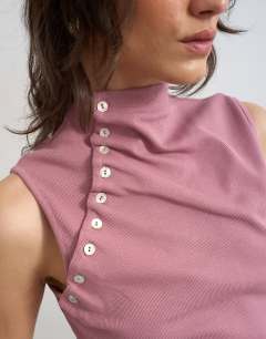Model wearing Asymmetric button detail sleeveless in mauve