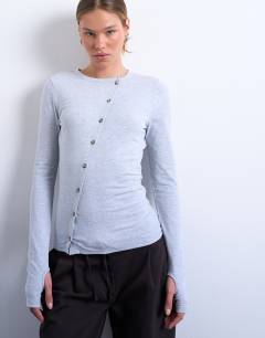 Model wearing Asymmetric button through long sleeve top in grey marl