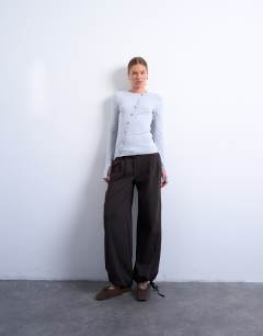 Model wearing Asymmetric button through long sleeve top in grey marl