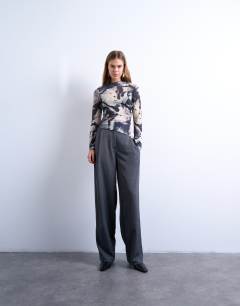 Model wearing Asymmetric drape abstract print top in multi