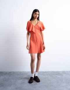 Model wearing Asymmetric frill mini dress in orange