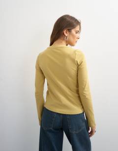 Model wearing Asymmetric long sleeve t-shirt in mustard