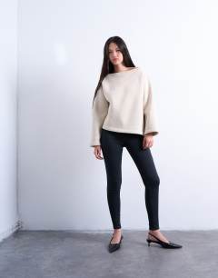 Model wearing Asymmetric off shoulder sweat in beige