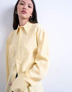 Model wearing Asymmetric placket shirt in yellow stripe