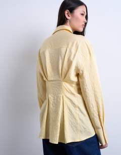 Model wearing Asymmetric placket shirt in yellow stripe
