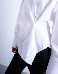 Model wearing Asymmetric placket waisted long sleeve shirt in white