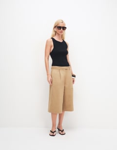 Model wearing Asymmetric racer back vest in black