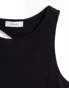 Model wearing Asymmetric racer back vest in black