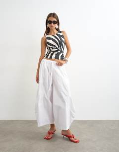 Model wearing Asymmetric racer back vest in zebra print