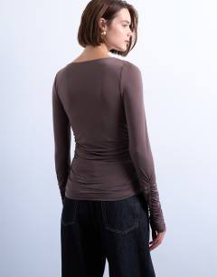Model wearing Asymmetric ruched long sleeve top in brown