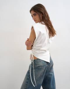 Model wearing Asymmetric ruched side top in white