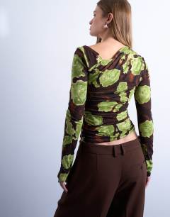 Model wearing Asymmetric slash neck floral print long sleeve top in green and brown
