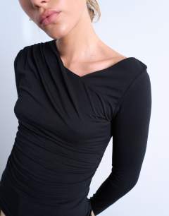 Model wearing Asymmetric slash neck long sleeve top in black