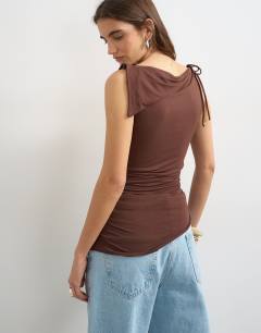 Model wearing Asymmetric tie shoulder tank in chocolate