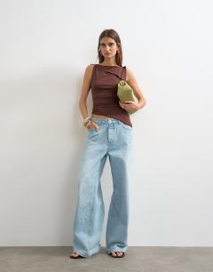 Model wearing Asymmetric tie shoulder tank in chocolate