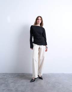 Model wearing Asymmetrical jersey slash neck long sleeve top in black