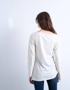 Model wearing Asymmetrical slash neck long sleeve top in off white