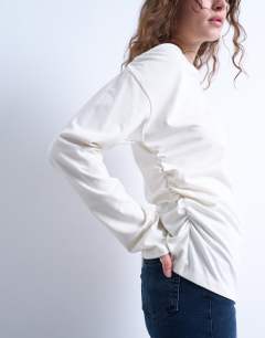 Model wearing Asymmetrical slash neck long sleeve top in off white