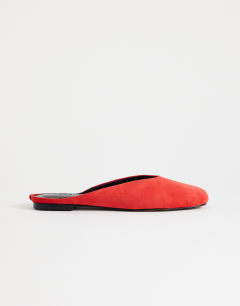 Model wearing Atlas mule flat shoe in red