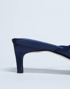 Model wearing Autumn minimal mid heel sandal in navy satin
