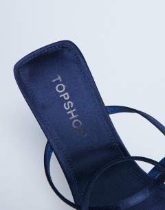 Model wearing Autumn minimal mid heel sandal in navy satin