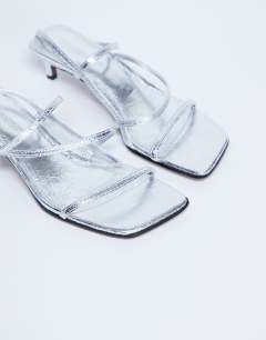 Model wearing Autumn minimal mid heel sandal in silver