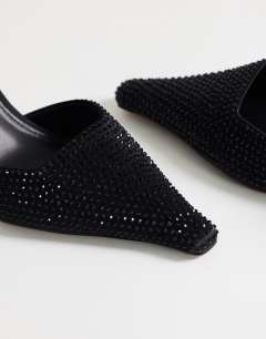 Model wearing Avery embellished pointed mule mid court in black