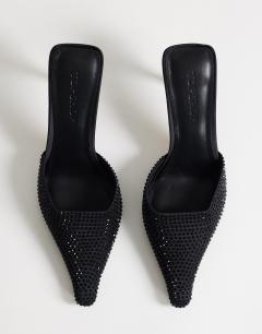 Model wearing Avery embellished pointed mule mid court in black